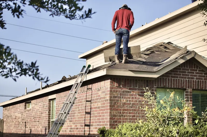 Professional roofer working on a residential roof in Evergreen Park